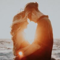 man and woman hugging during golden hour