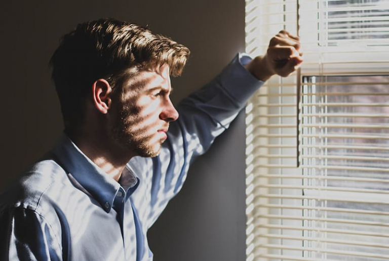 man standing near window