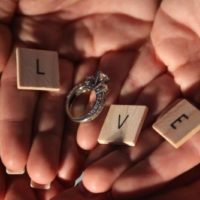 hands with love letters and ring