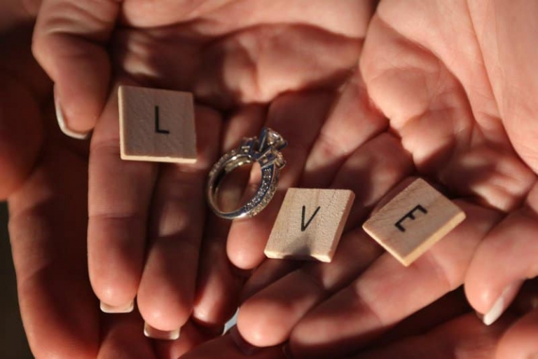 hands with love letters and ring