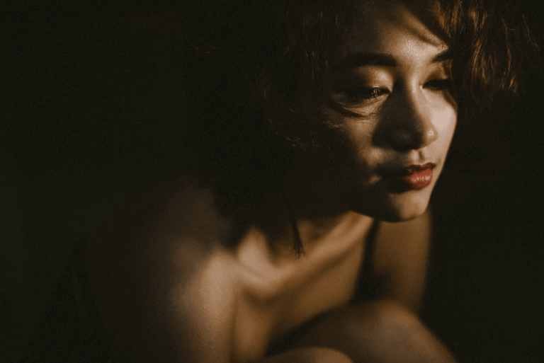 close-up photo of woman in dark room