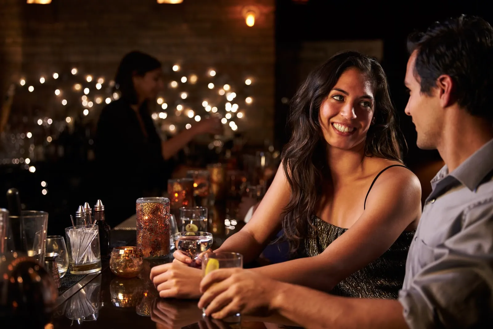 Couple Enjoying Night Out At Cocktail Bar