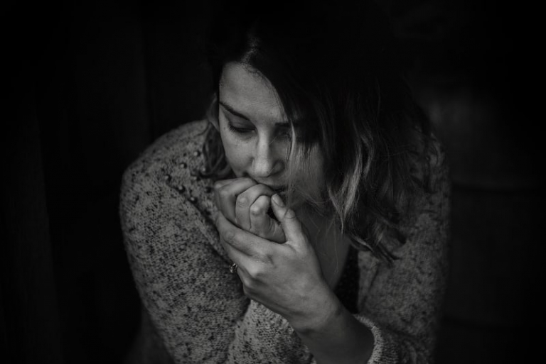 sad woman in sweater sitting indoor