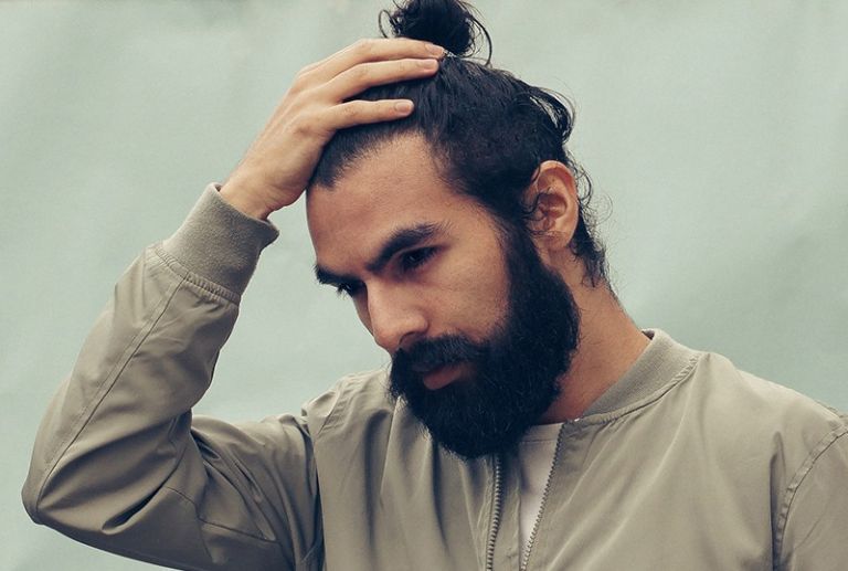 man holding his black hair