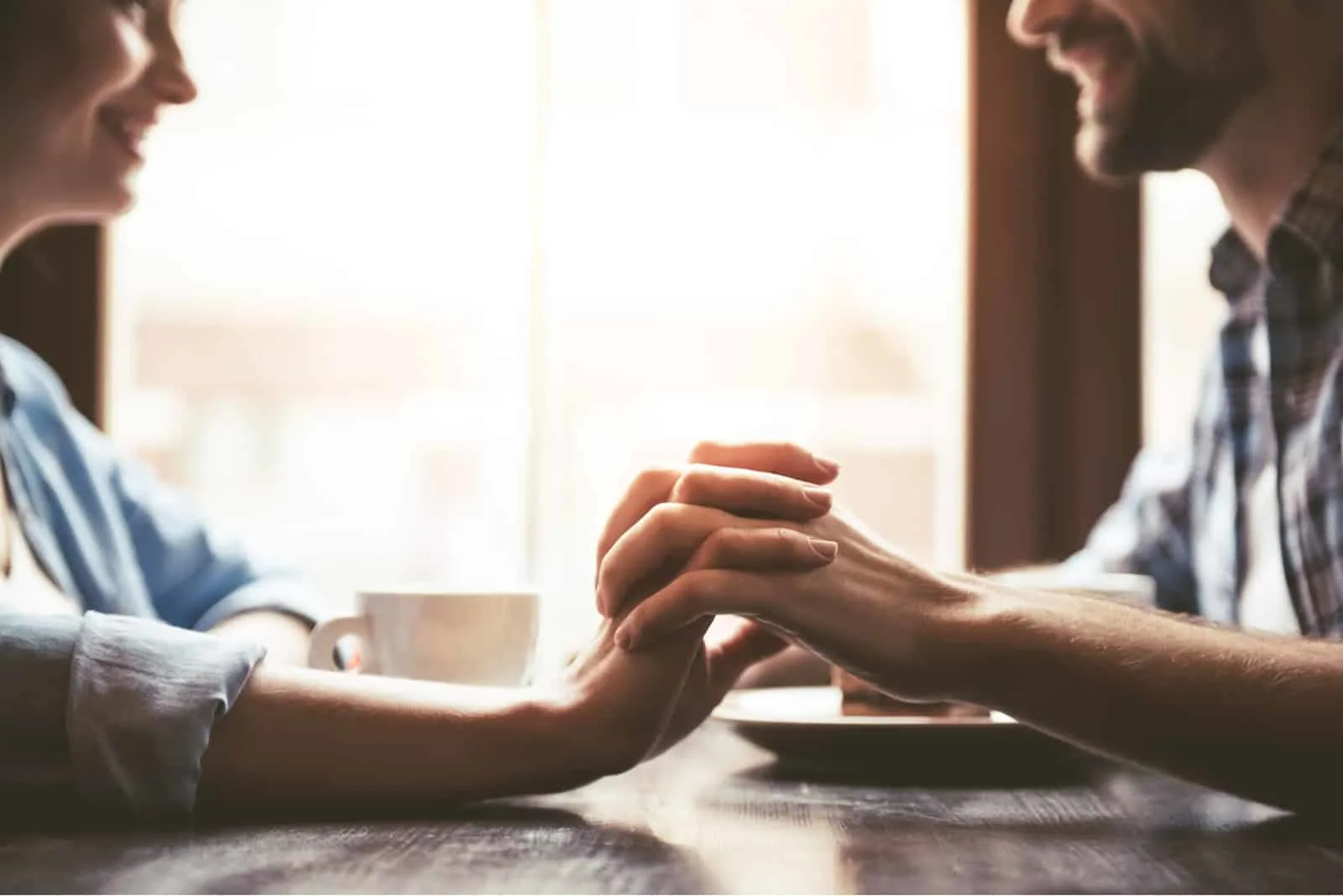 a man and a woman sit and hold hands
