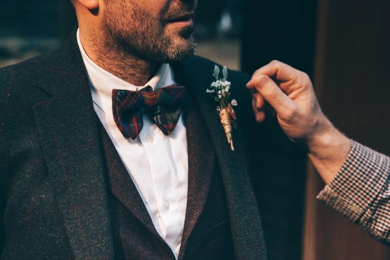 a man in a suit with a bow tie