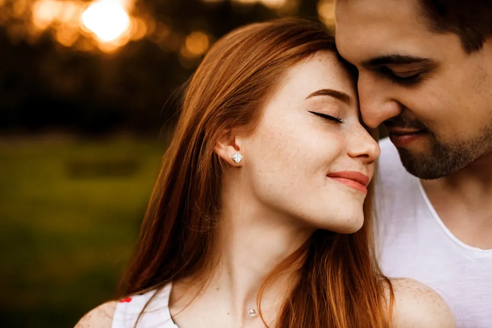 a portrait of a romantic loving couple outside
