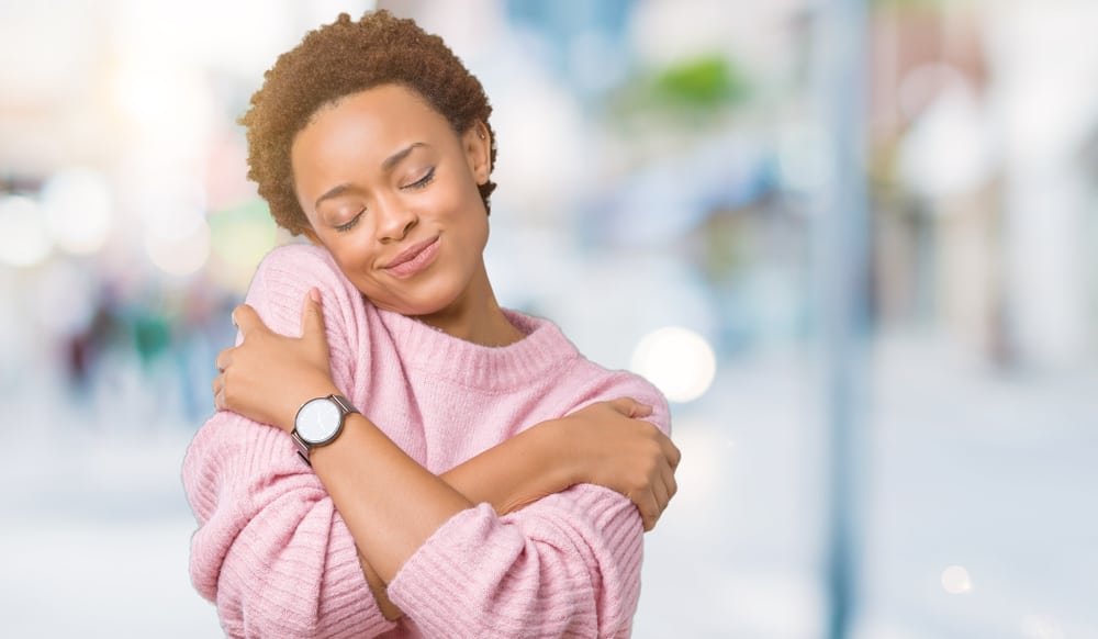 beautiful woman hugging herself