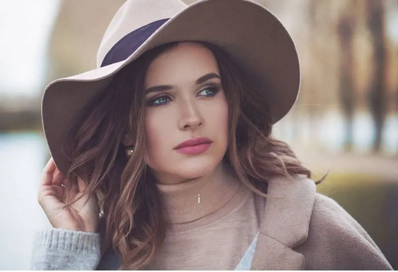 beautiful woman wearing big hat with brown jacket