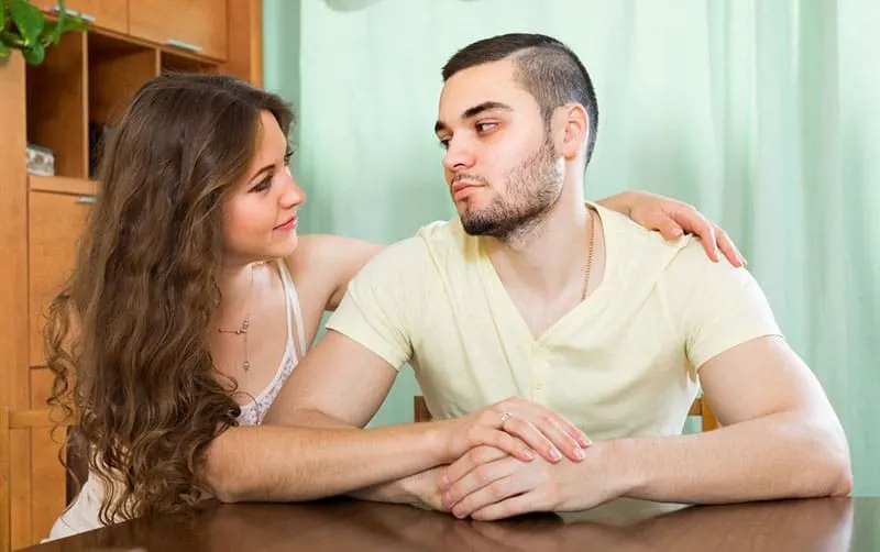loving young woman tries to reconcile with a man after a quarrel