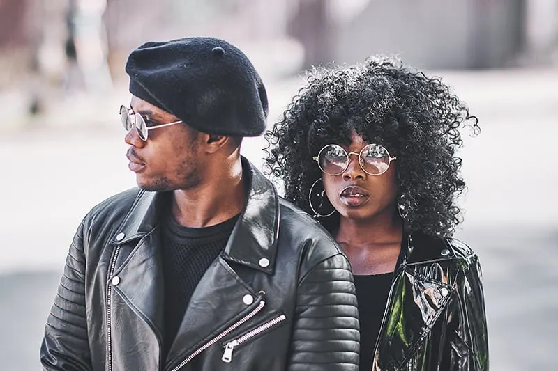 man and woman in black leather jackets standing together