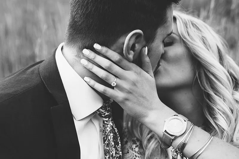 man and woman kissing while woman touching man`s neck