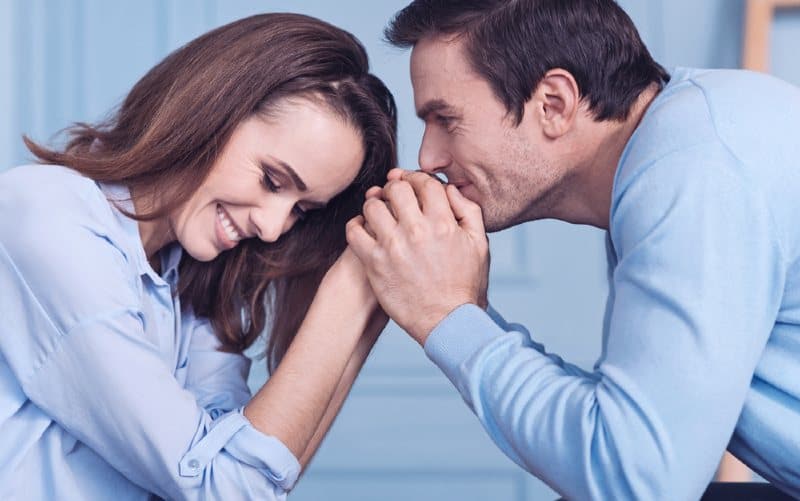 man and woman in blue shirts holding hands
