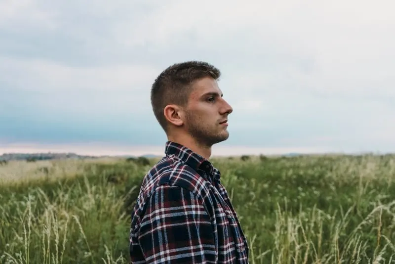 man standing on grass field
