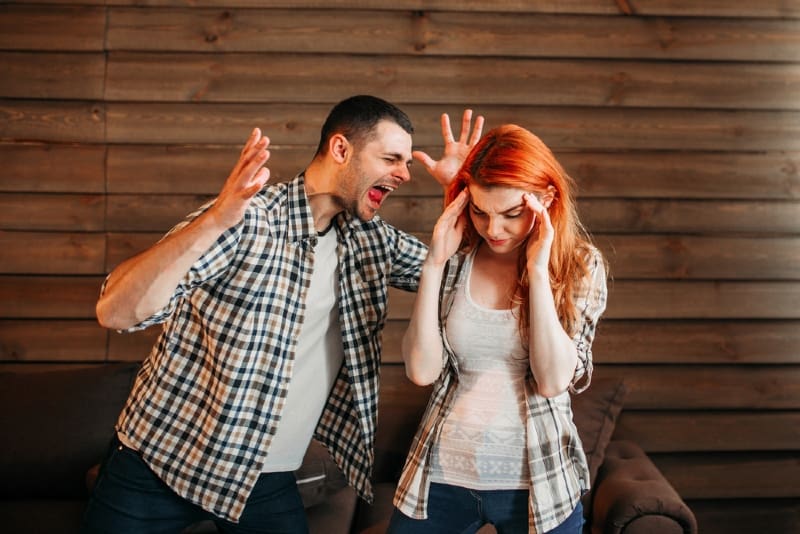 man yelling at woman while standing indoor