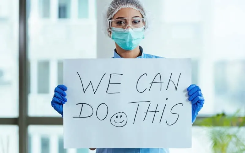 Nurse holding paper with We can do this message