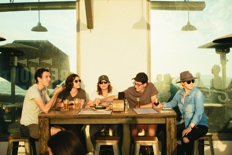 five people sitting on chairs outdoor