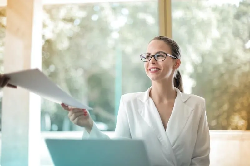positive woman receiving paper in a positive manner inside office