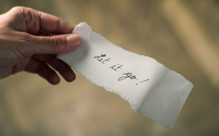 Hand holding let go note