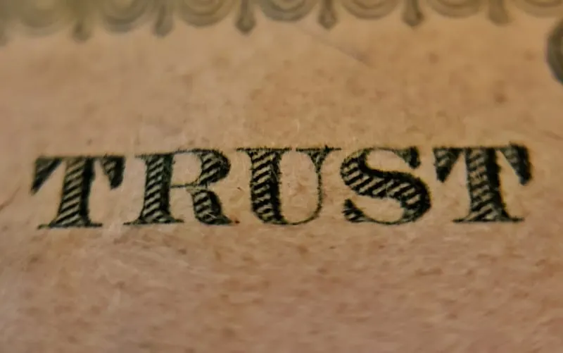 Trust text written on brown surface