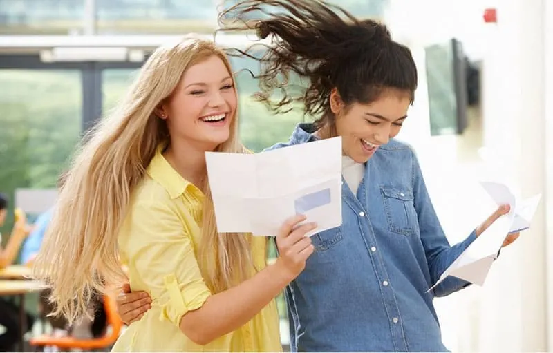 two women celebrating test results with good scores