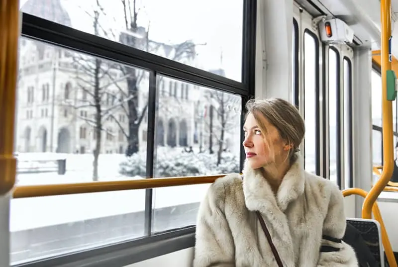 woman in warm clothes in public transport