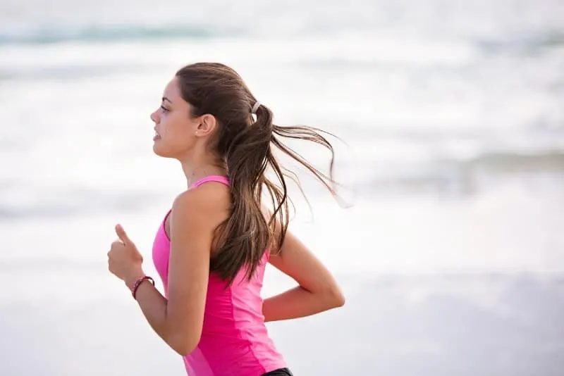 young woman in pink top jogging