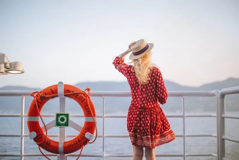 woman in red dress looking at sea