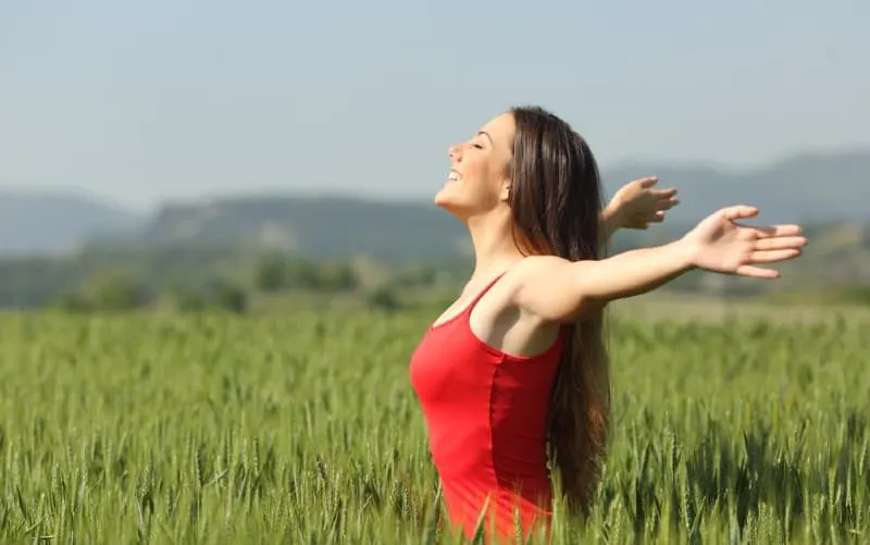 Woman in red dress on green field
