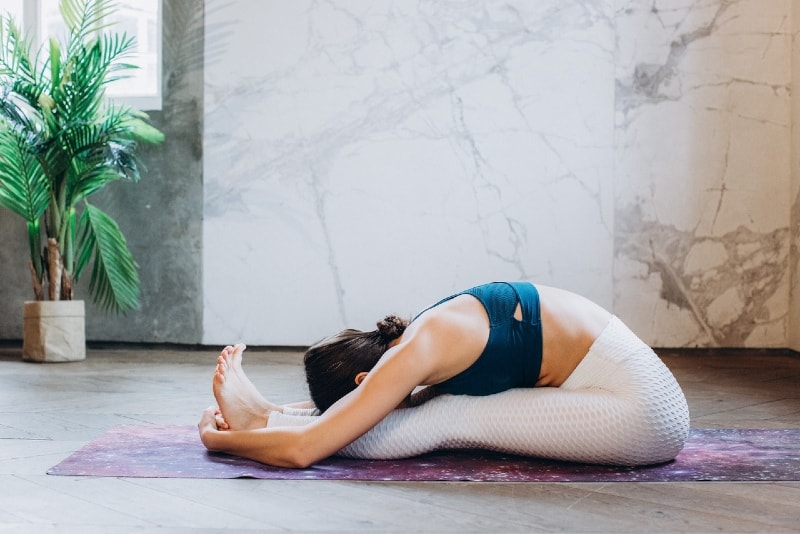 woman in black top practicing yoga indoor