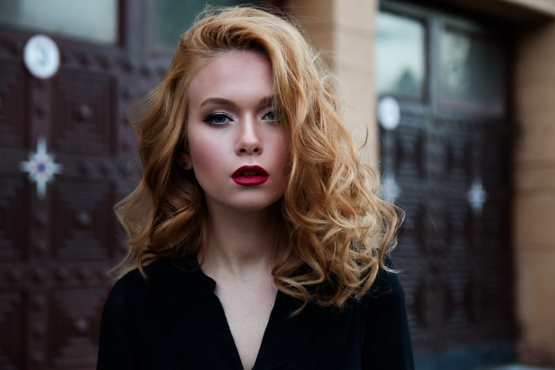 woman with red lipstick standing outdoor