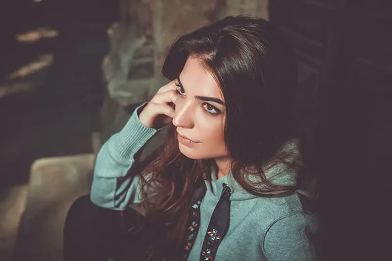 woman with long brown sitting near door