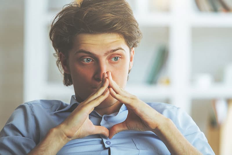 worried man with blue eyes in deep thoughts