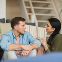 couple sitting looking at each other