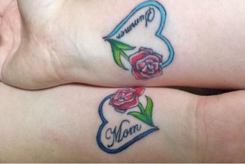 Tatuaggio colorato di una rosa inchiostrata su una parte delle braccia