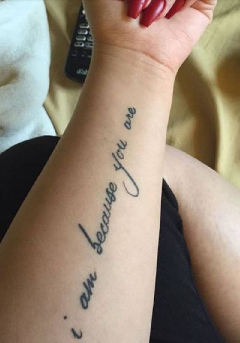Tatuaggio "Io sono perché tu sei" inciso sulle braccia
