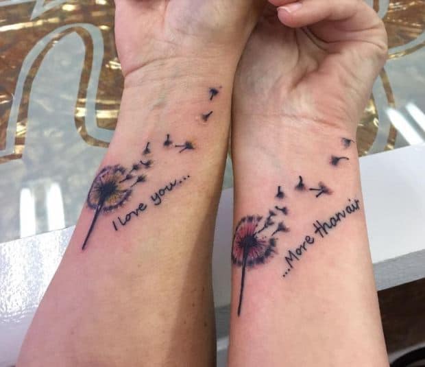 I love you more…’ tattoo inked on two persons hand