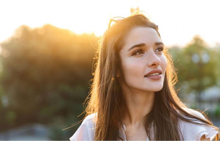 beautiful woman smiling looking far standing outdoors