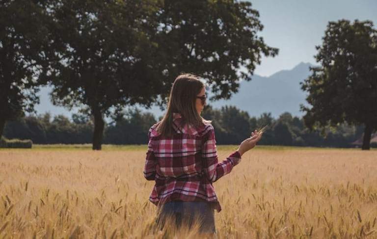 woman contemplating the the grainfield