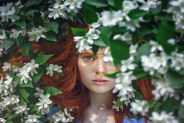 woman standing near white flowers