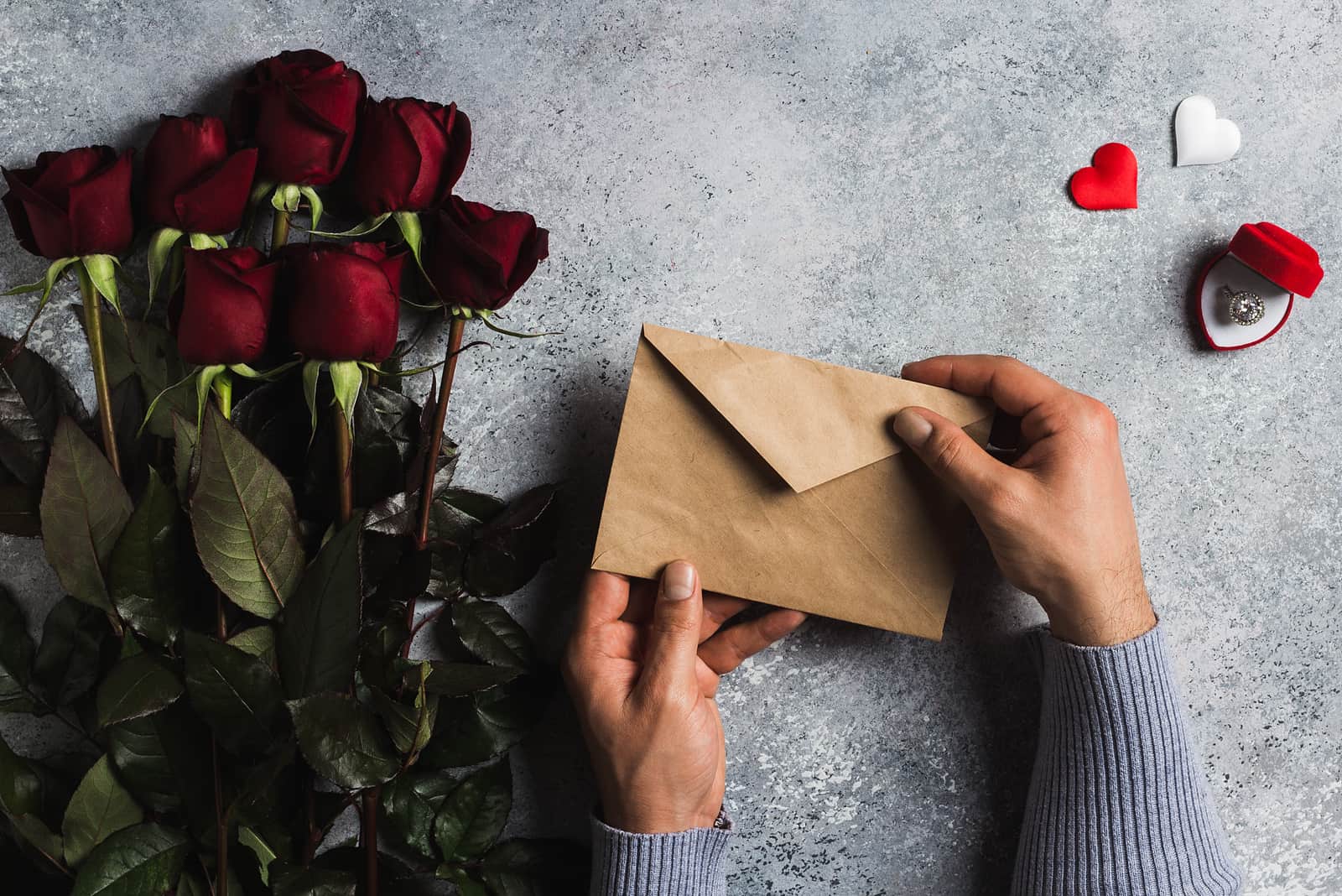 a man holds an envelope in his hand