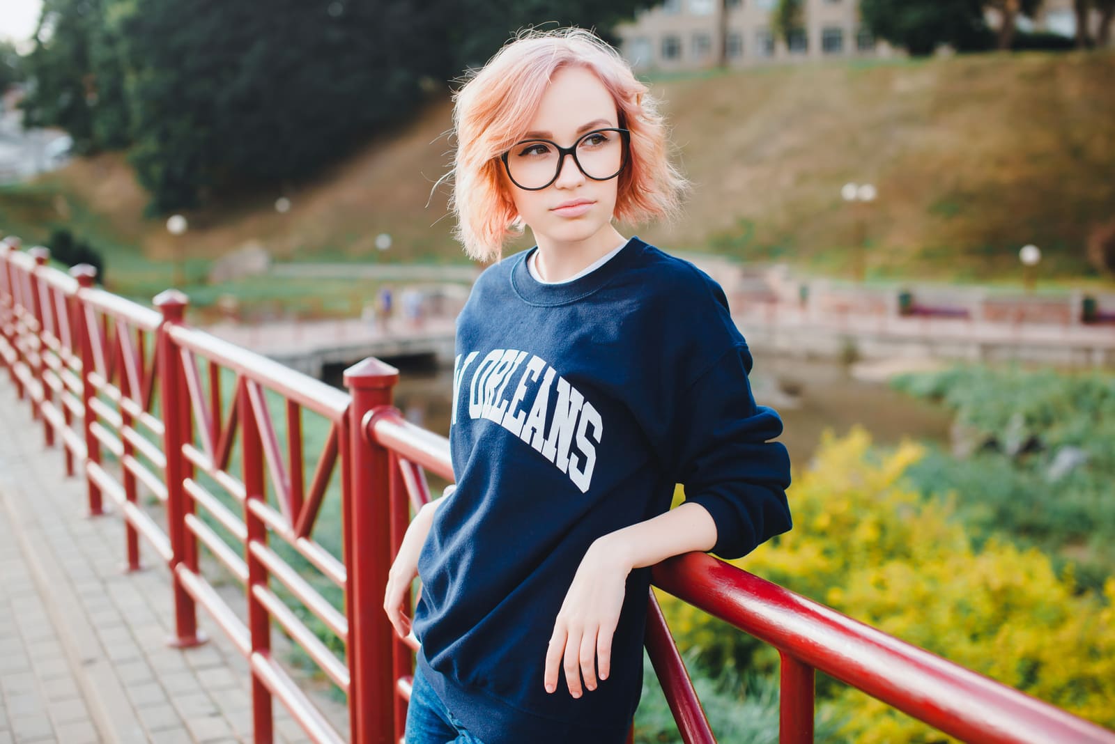 a woman standing on a bridge