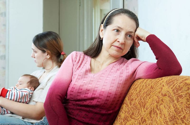 adult woman silent treatment against adult daughter with a baby she carry