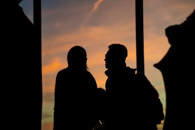 man and woman talking during sunset