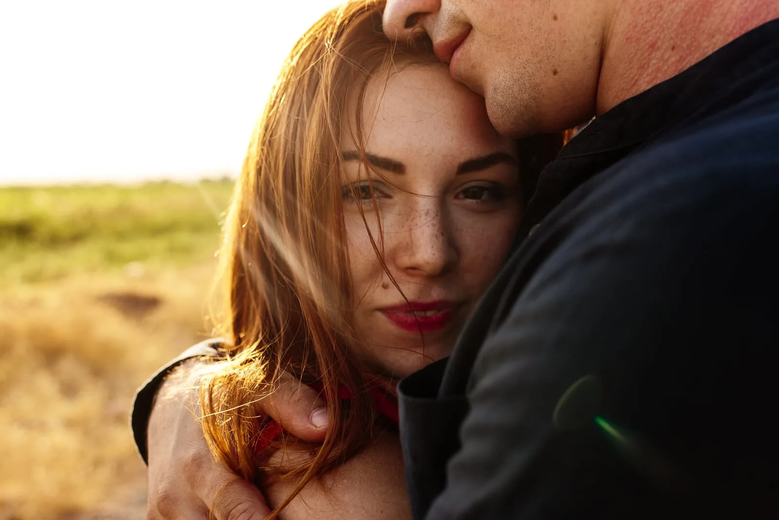 man hugging woman