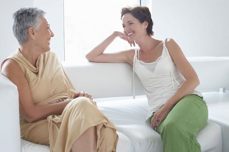 mother and daughter in law talking in the sofa