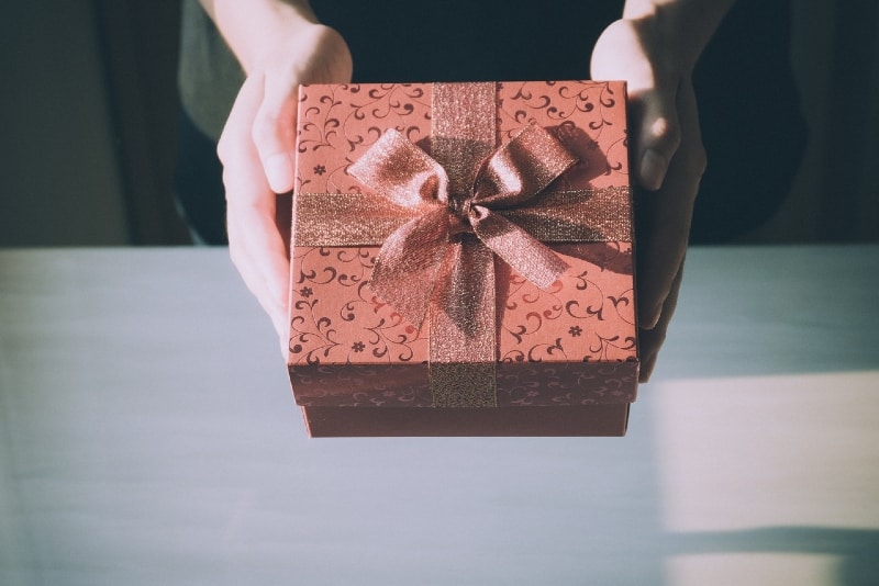 person holding brown gift box