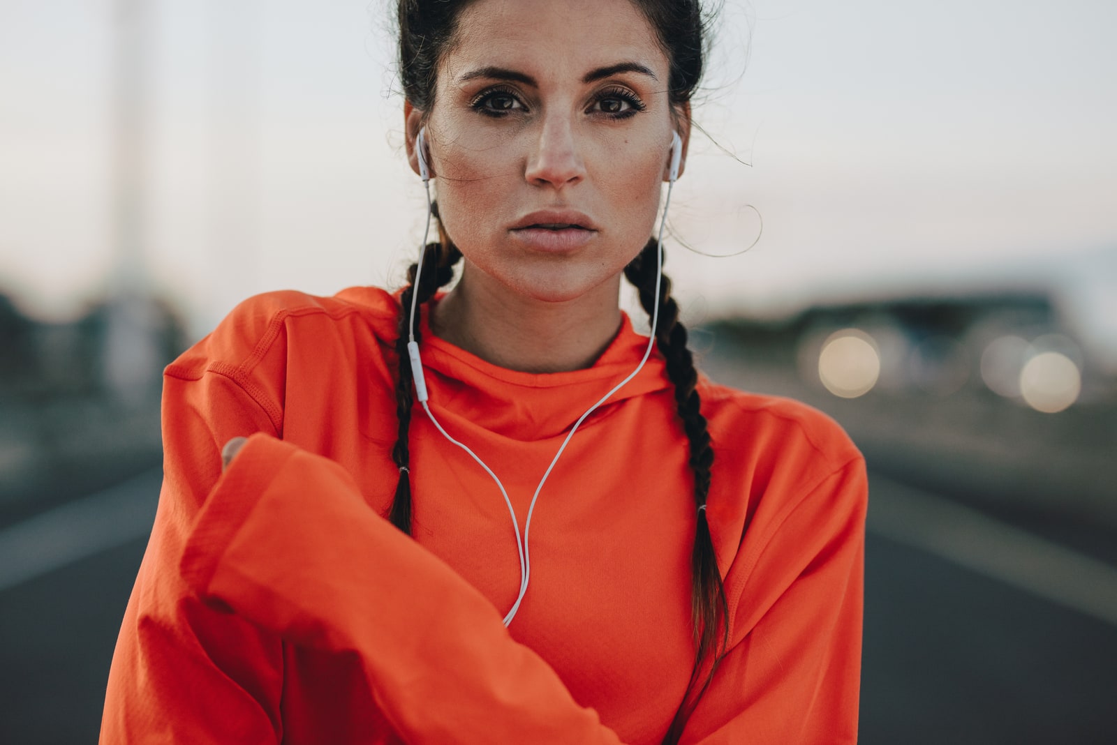 portrait of a brunette in an orange hoodie