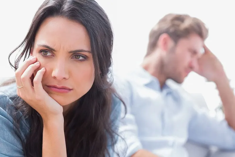 sad woman looking away from man on the other side