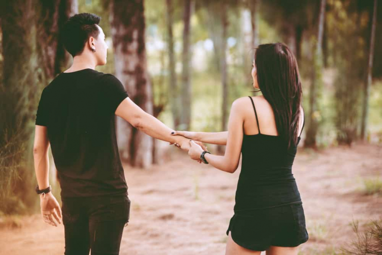 sad woman looking boyfriend leaving her